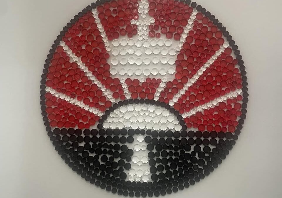 Eco mural: our school badge made from recycled bottle tops